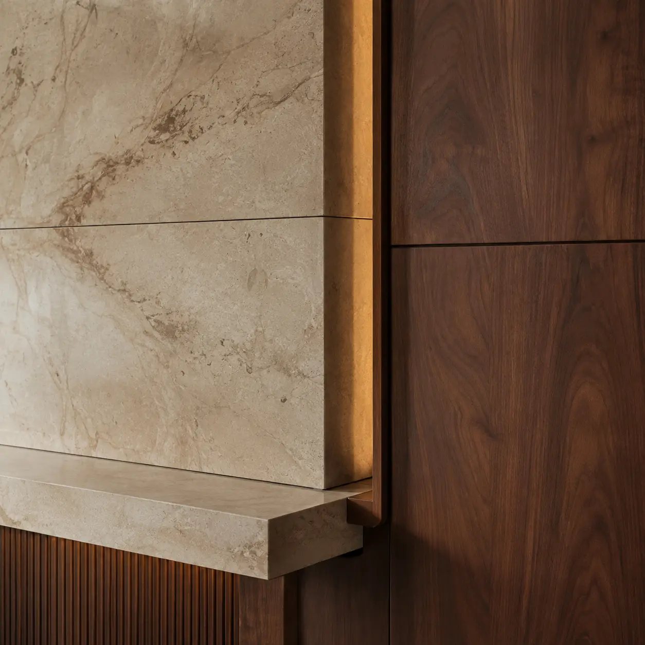 Natural stone meeting walnut joinery through a bronze shadow-gap detail